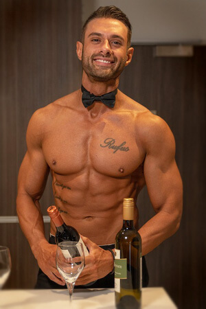 hot topless waiter wearing bow tie and pouring drinks