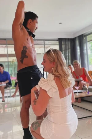 Topless waiter serving drinks at life drawing party