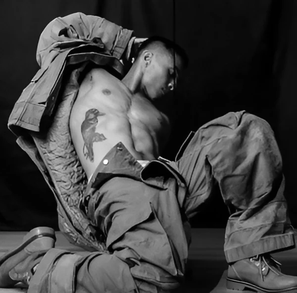 Hens Knights male stripper posing with tattoos as Fireman