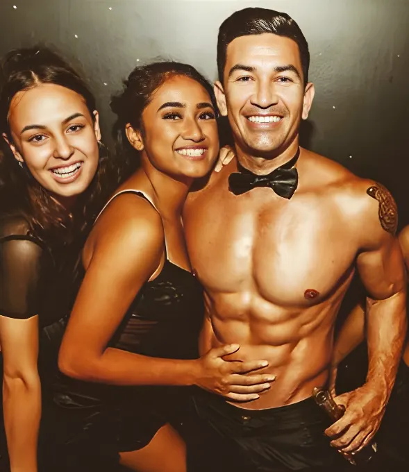 Brisbane topless waiter Miguel posing with hens party guests at a cheeky celebration