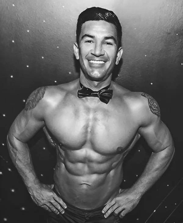 Hens Knights male stripper with bow tie and muscular physique